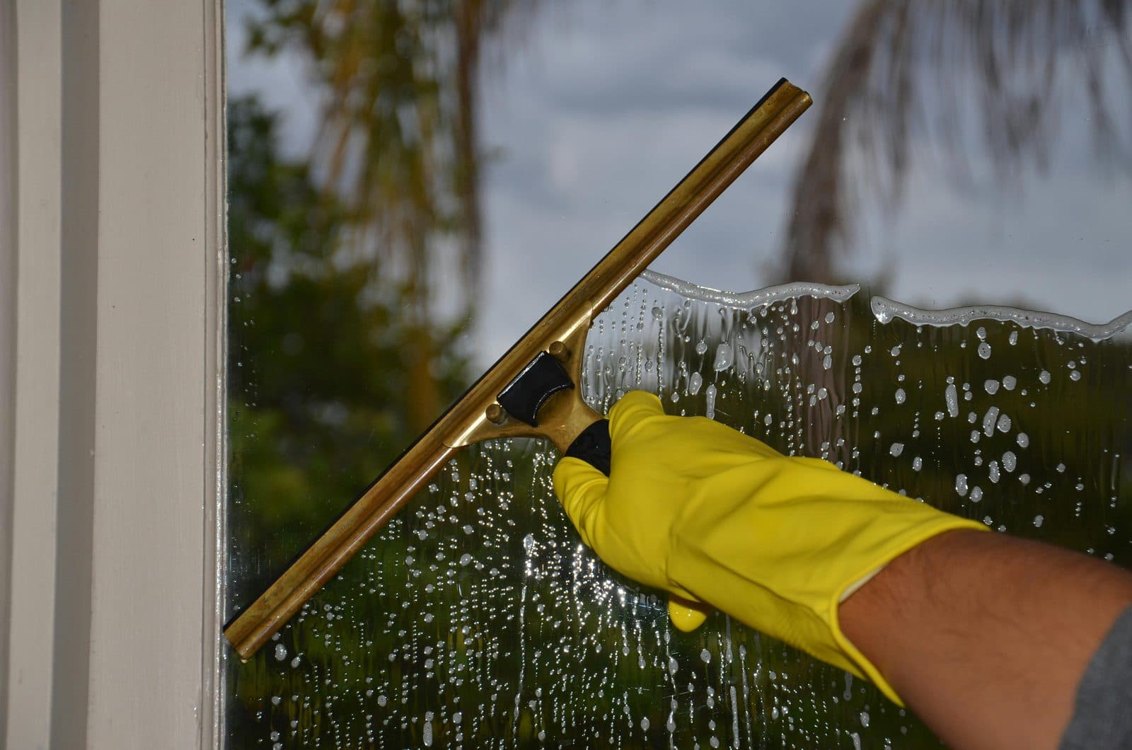 Window cleaner using a water-fed pole to reach-and-wash a property's upper windows